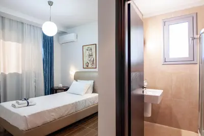 a hotel room with a bed and a sink at Bella Foresta Villa in Ialyssos