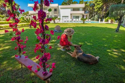 a statue of a girl and a deer in the grass at Bella Foresta Villa in Ialyssos