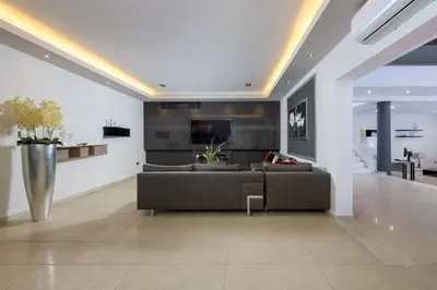 a living room with a couch and a tv at Bella Foresta Villa in Ialyssos