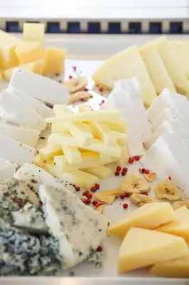 a bunch of cheese and other foods on a plate at Delfinia Resort - All Inclusive in Kolimbia