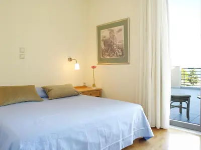 a bedroom with a blue bed and a window at Luxury Villa Trapezia in Afantou