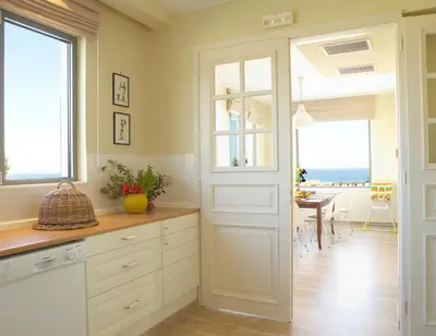 a kitchen with a door leading to a dining room at Luxury Villa Trapezia in Afantou