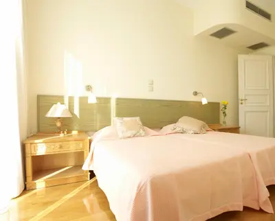 a bedroom with a large bed with a white bedspread at Luxury Villa Trapezia in Afantou