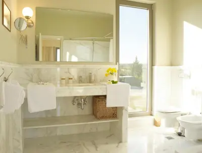 a bathroom with a sink and a mirror and a toilet at Luxury Villa Trapezia in Afantou