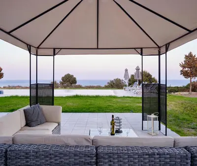 a large tent with couches and a table at Luxury Villa Trapezia in Afantou