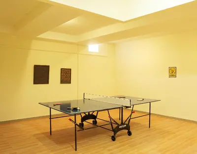 a ping pong table in the middle of a room at Luxury Villa Trapezia in Afantou