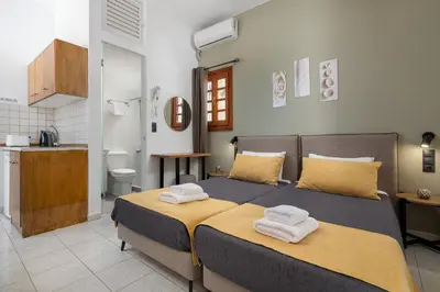 a bedroom with a bed with towels on it at Flora Studios in Líndos
