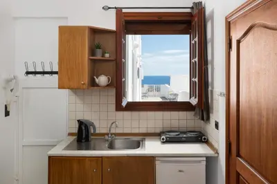 a kitchen with a sink and a window at Flora Studios in Líndos