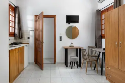 a kitchen with a table and a dining room at Flora Studios in Líndos