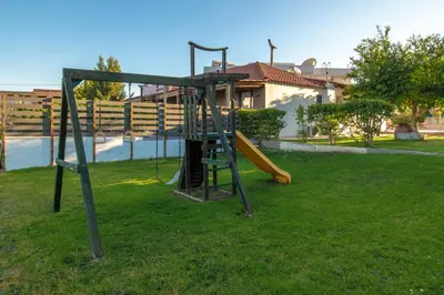a playground in a yard with a slide at Bright Star in Faliraki