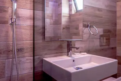 a bathroom with a white sink and a shower at Bright Star in Faliraki