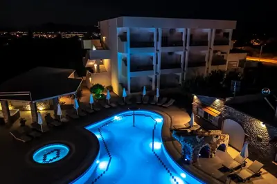 an overhead view of a swimming pool at night at Bright Star in Faliraki