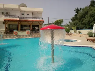 a fountain in the middle of a swimming pool at Bright Star in Faliraki