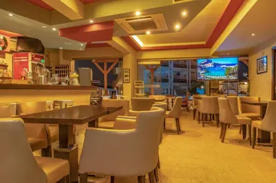 a restaurant with a bar and tables and chairs at Bright Star in Faliraki