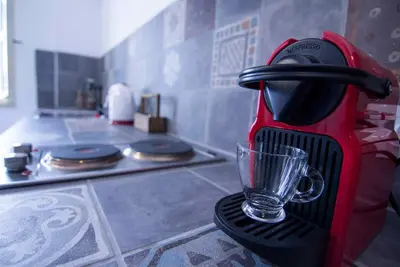 a mixer sitting on a counter with a glass on it at Aegli Apartments in Symi