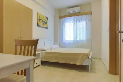 a small bedroom with a bed and a window at International Hotel in Rhodes Town