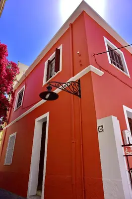 a red building with a door and a window at Villa Mariza 1920 in Rhodes Town