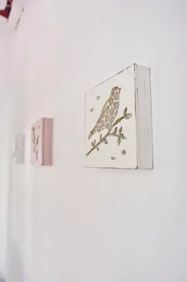 a framed picture of a bird on a branch at Villa Mariza 1920 in Rhodes Town