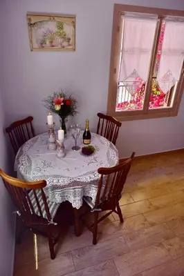 a table with a vase of flowers on it at Villa Mariza 1920 in Rhodes Town