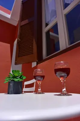 two glasses of wine sitting on a table at Villa Mariza 1920 in Rhodes Town