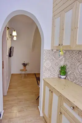 a kitchen with an archway leading to a dining room at Villa Mariza 1920 in Rhodes Town