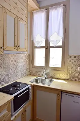 a kitchen with a sink and a stove and a window at Villa Mariza 1920 in Rhodes Town