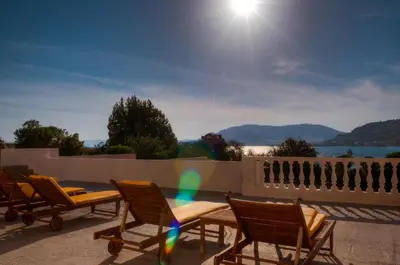 a group of chairs and a table on a patio at Anthi Maria Beach Apartments in Pefki Rhodes