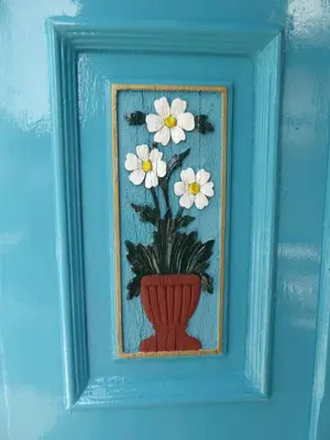 a picture of a vase with white flowers in it at Halki Townhouse in Halki