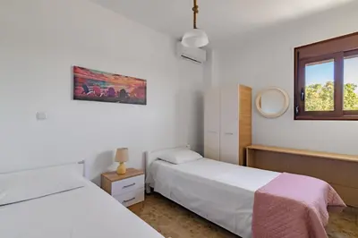 a bedroom with two beds and a window at Villa Nastazia in Kiotari