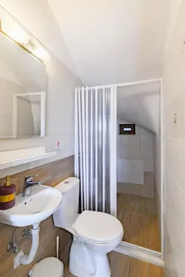 a bathroom with a toilet and a sink and a shower at Villa Nastazia in Kiotari