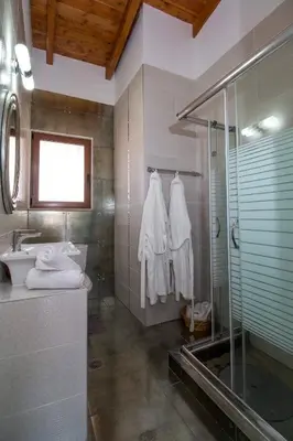 a bathroom with a shower and a sink at Emerald Dream Apartment in Faliraki