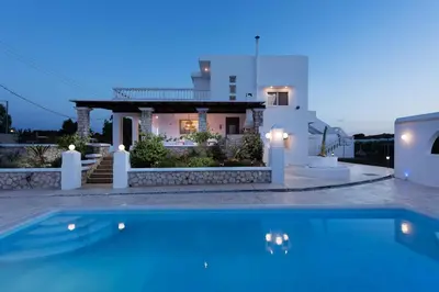 a house with a swimming pool in front of a house at Villa Dimitra Gennadi in Gennadi