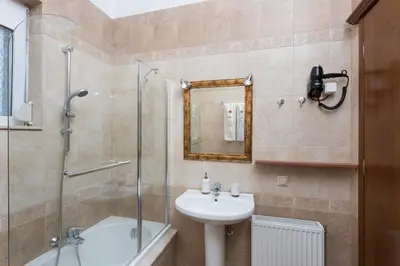a bathroom with a sink and a glass shower at Villa Dimitra Gennadi in Gennadi