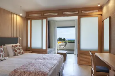 a hotel room with a bed and a balcony at Atlantica Mikri Poli Rhodes in Kolimbia