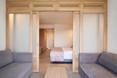 a living room with two couches and a bed at Atlantica Mikri Poli Rhodes in Kolimbia