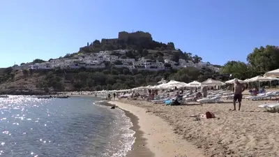 a group of people on a beach with a hill at Villa Vasilia in Líndos