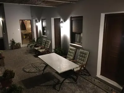 a room with chairs and a table and a table at Villa Vasilia in Líndos