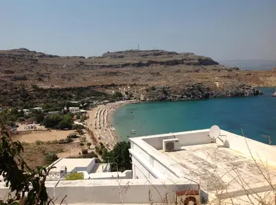a view of a beach with a hill in the background at Villa Vasilia in Líndos
