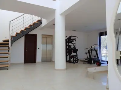 a room with a gym with a spiral staircase at Villa Anastasia in Psinthos