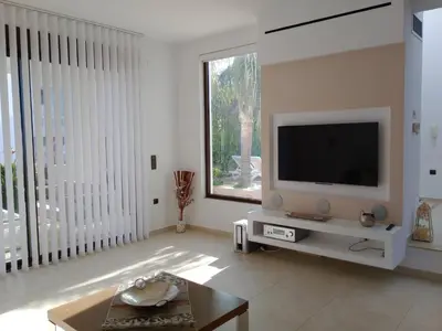 a living room with a television on a table at Villa Anastasia in Psinthos