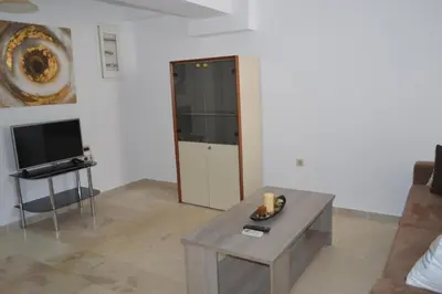 a living room with a table and a tv at Anthi City Center Apartment in Rhodes Town