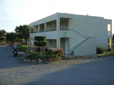 a building with a motorcycle parked in front of it at Sifis Studios Pefkos in Pefki Rhodes