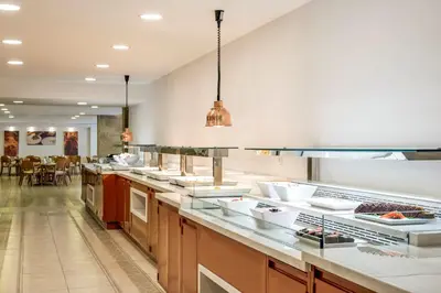 a kitchen with a long counter with many dishes at Pearl Hotel in Rhodes Town