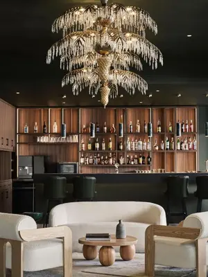 a chandelier in a bar with a white couch and chairs at Pearl Hotel in Rhodes Town