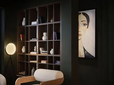 a book shelf with a portrait of a woman at Pearl Hotel in Rhodes Town