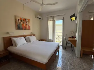 a bedroom with a bed and a desk and a window at Florida Hotel & Apartments - Adults Only in Rhodes Town