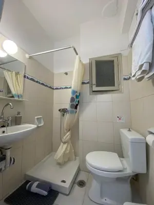 a small bathroom with a toilet and a sink at Florida Hotel & Apartments - Adults Only in Rhodes Town