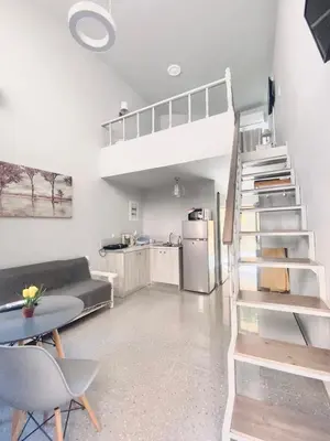 a living room with a loft bed and a kitchen at Florida Hotel & Apartments - Adults Only in Rhodes Town