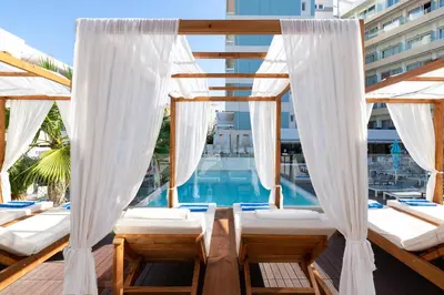 a balcony with beds and a swimming pool at Arte Hotel in Rhodes Town