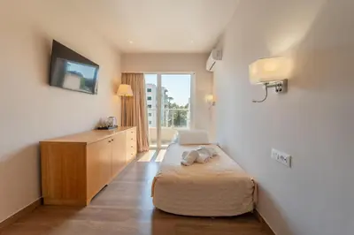 a bedroom with a bed with a laptop on it at Arte Hotel in Rhodes Town
